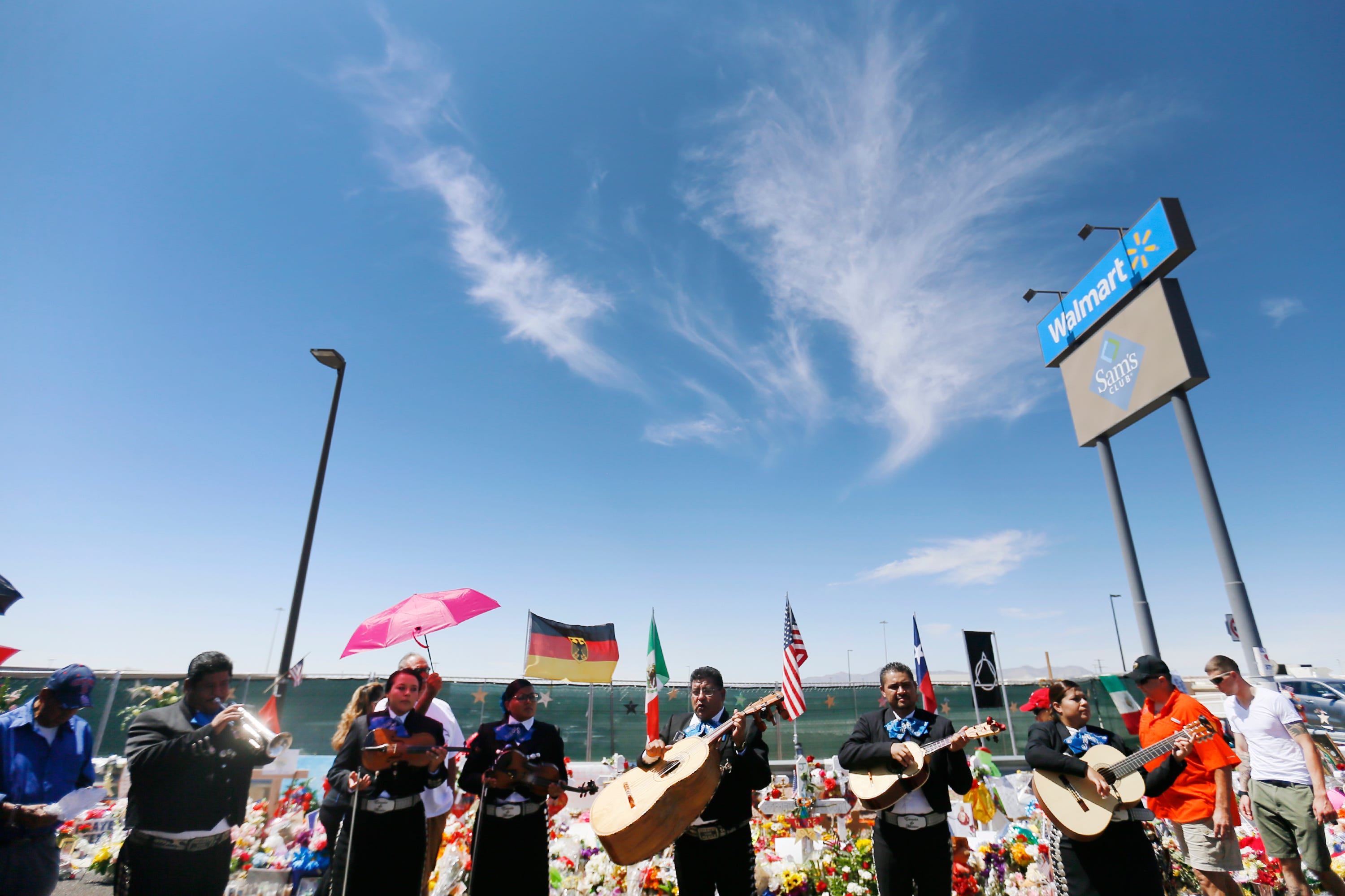 A procession of 22 hearses fills the Walmart shooting memorial site to honor all of the victims of the Aug. 3 attack Sunday, Aug. 18, in El Paso. The flowers were sent from across the world for the funeral services for Margie Reckard.