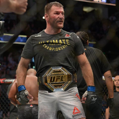 Stipe Miocic is awarded the championship belt...