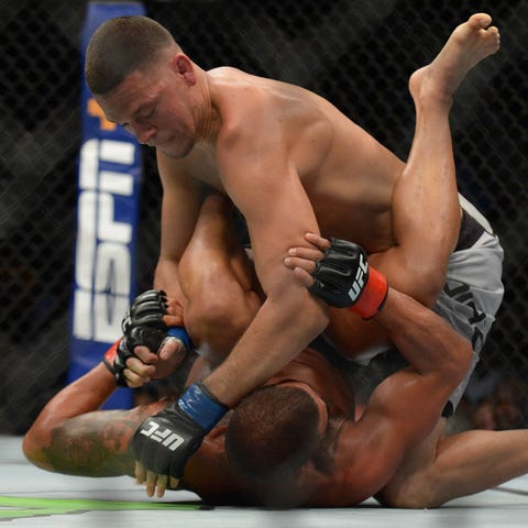 Nate Diaz pins Anthony Pettis to the mat.