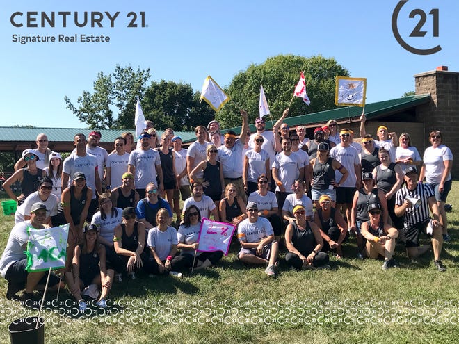 Century 21 Signature Real Estate employees pose during their annual "Office Olympics." It's one of the activities leadership says helps foster a community environment among employees.