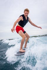 Jake Tasker of Buffalo, NY attempts wake surfing for the first time on Lake Michigan.