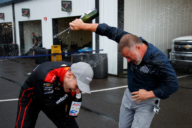 Will Power, left, celebrates with Pocono Raceway's Nick Igdalsky after winning an IndyCar Series auto race Sunday at Pocono in Long Pond, Pa.
