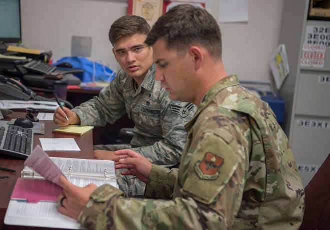 Staff Sgt. Clement Bouloiseau, 49th Wing Safety and Occupational Health specialist, goes through a safety inspection binder with Senior Airman Theodore Warren, 49th Civil Engineer Squadron unit deployment manager, Aug. 14, 2019, on Holloman Air Force Base, N.M. Safety and Health Occupations specialists perform annual facility inspections for various units on base and some Air Force units on Fort Bliss, Texas.
