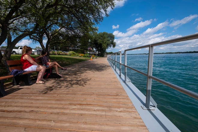 Stephanie Cinner and Diana Beauchamp sit with Zoe, an 8-year-old Golden Doodle, on a bench along the boardwalk in St. Clair Monday, Aug. 19, 2019. .