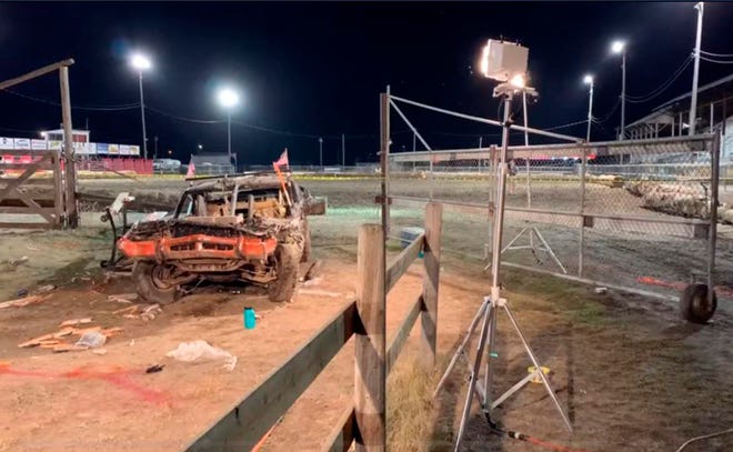 This Sunday, Aug. 18, 2019, image provided by ABC Fox Montana, shows the scene where a woman died after a car flew through a fence into spectators at a demolition derby in Deer Lodge, Montana. The Montana Standard reports at least eight people were sent to the hospital Sunday after a driver lost control of the car. Authorities say a woman in her 40s died at the hospital after being transported from Powell County Fairgrounds in Deer Lodge about 80 miles (130 kilometers) southeast of Missoula. (Brooke McCarthy/ABC Fox Montana via AP)