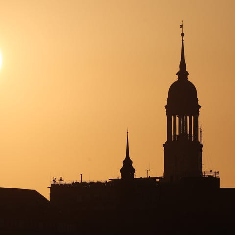 The sun rises behind the St. Michaels church in Ha