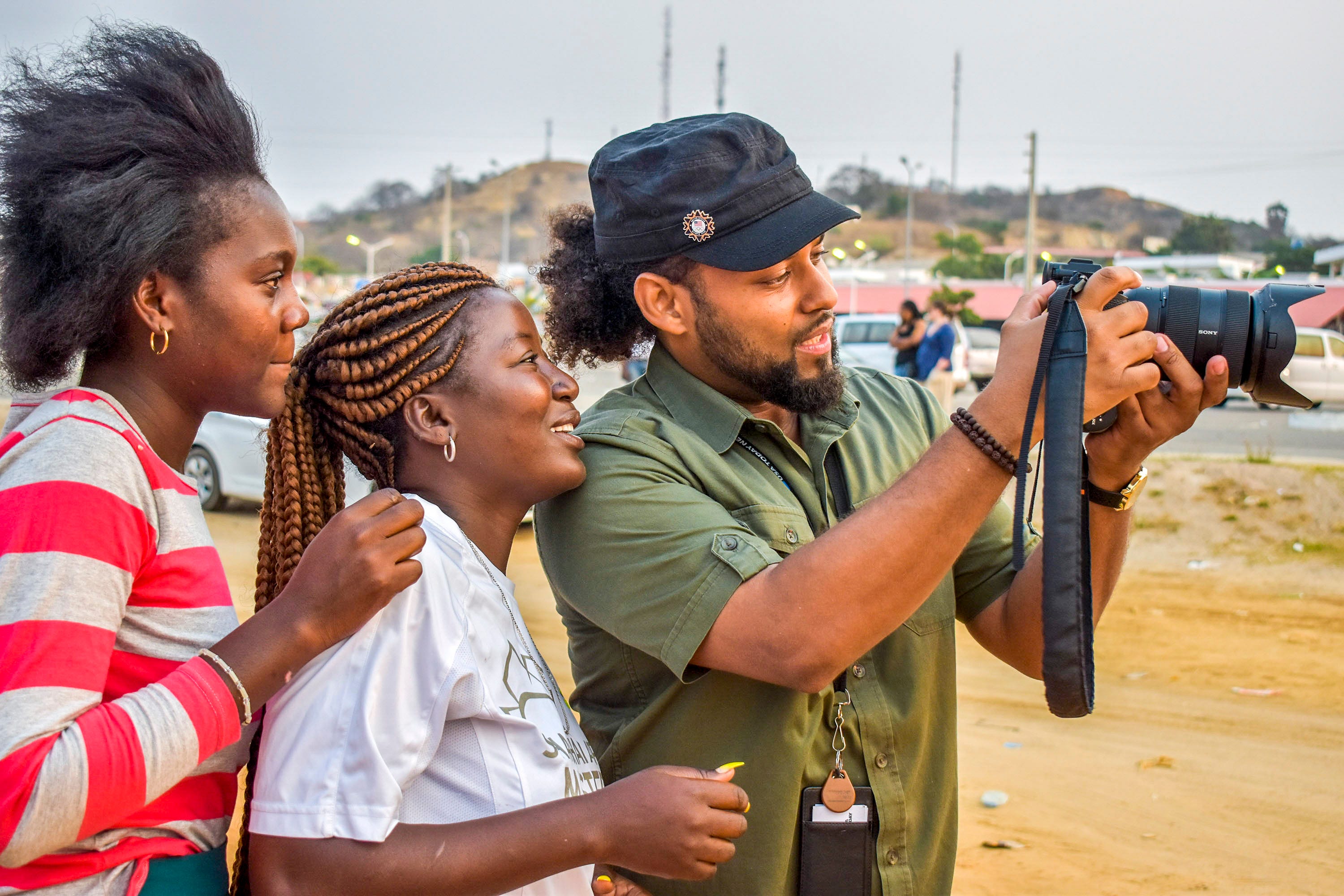 Even while carrying dozens of pounds in gear to chronicle Wanda Tucker's story with photos and video, Jarrad Henderson shows off his screen while shooting video portraits for the series.