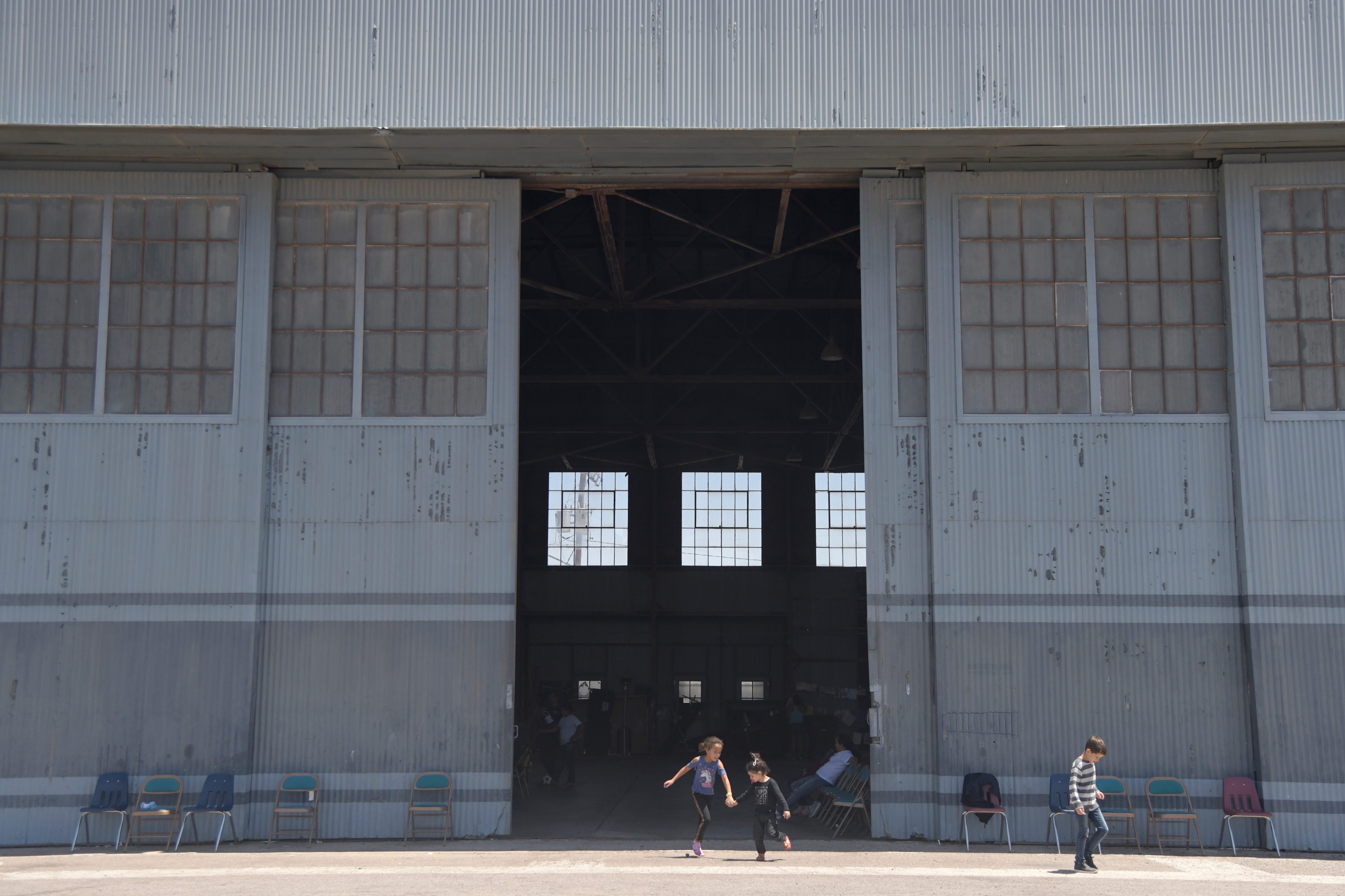 DEMING, N.M. – Children play outside a temporary shelter on June 25, 2019. The shelter mainly sees Central American and Brazilian families seeking asylum.