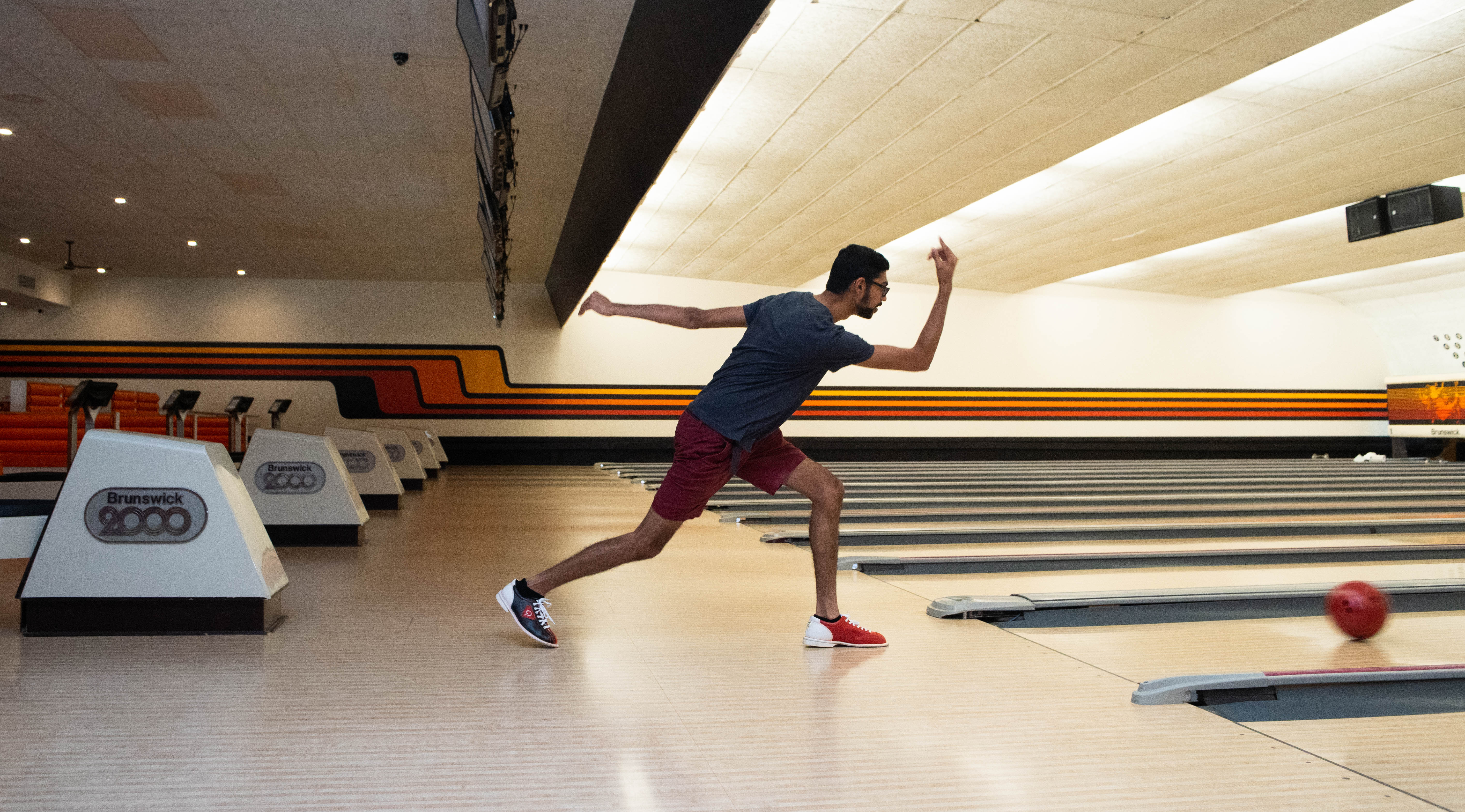 Kush Pateo, 20, of Sterling Heights bowls a frame with friends at Bowlero Lanes & Lounge in Royal Oak.