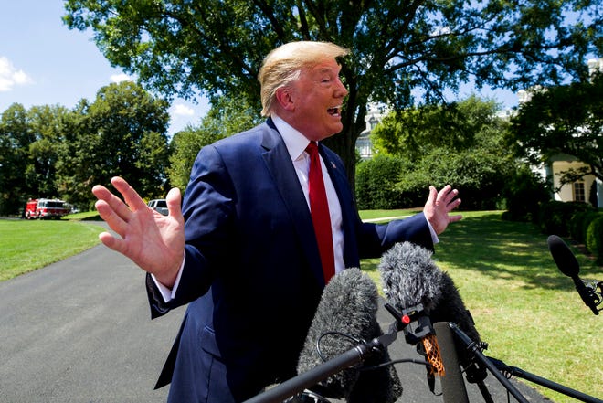 President Donald Trump speaks with reporters on the South Lawn of the White House, Wednesday, Aug. 21, 2019. Trump said he is working with Republican and Democratic lawmakers to enhance background checks for gun purchases, denying reports that he had abandoned the idea after meeting with the National Rifle Association.