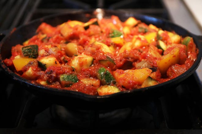 Ratatouille typically consists of roughly equal amounts of eggplant, zucchini and bell pepper, flavored with onion, garlic and herbs. Tomato is added in direct proportion to the cook's tastes.