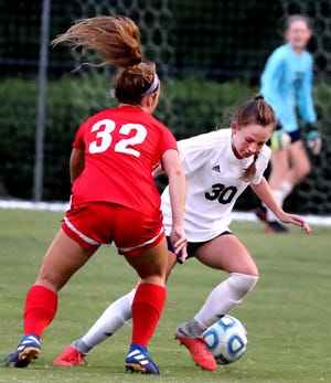 Siegel's Madison Whitworth (30) tries to deflect the ball as Oakland's Avery Casteel (32) tries to get to the goal on Tuesday Aug. 20, 2019, at Siegel Park. 
