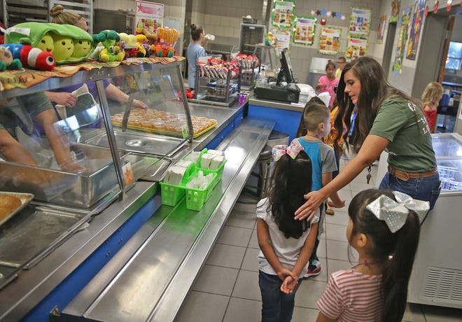Meagan Underhill, far right, helps students with a practice run on how to navigate the lunch line on the first day of class at Goliad Elementary School on Wednesday, August 21, 2019.