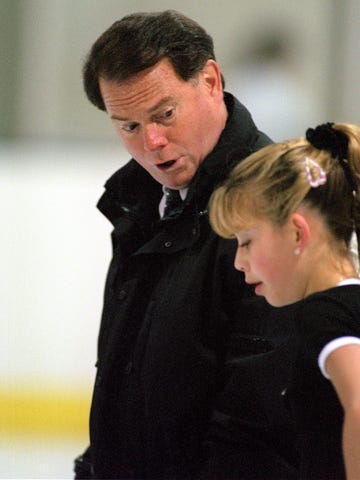 Richard Callaghan, shown in 1997 working with Tara Lipinski, was banned by the U.S. Center for SafeSport on Wednesday.