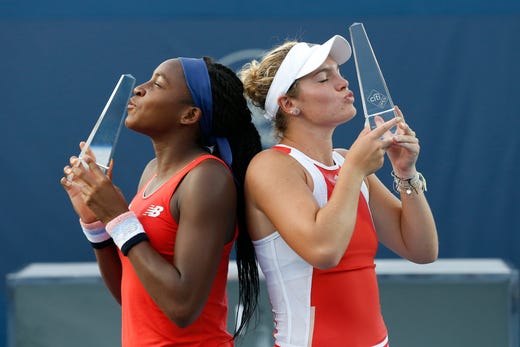 Coco Gauff and Catherine Mcnally pose with their trophies after the women's doubles final at the 2019 Citi Open.