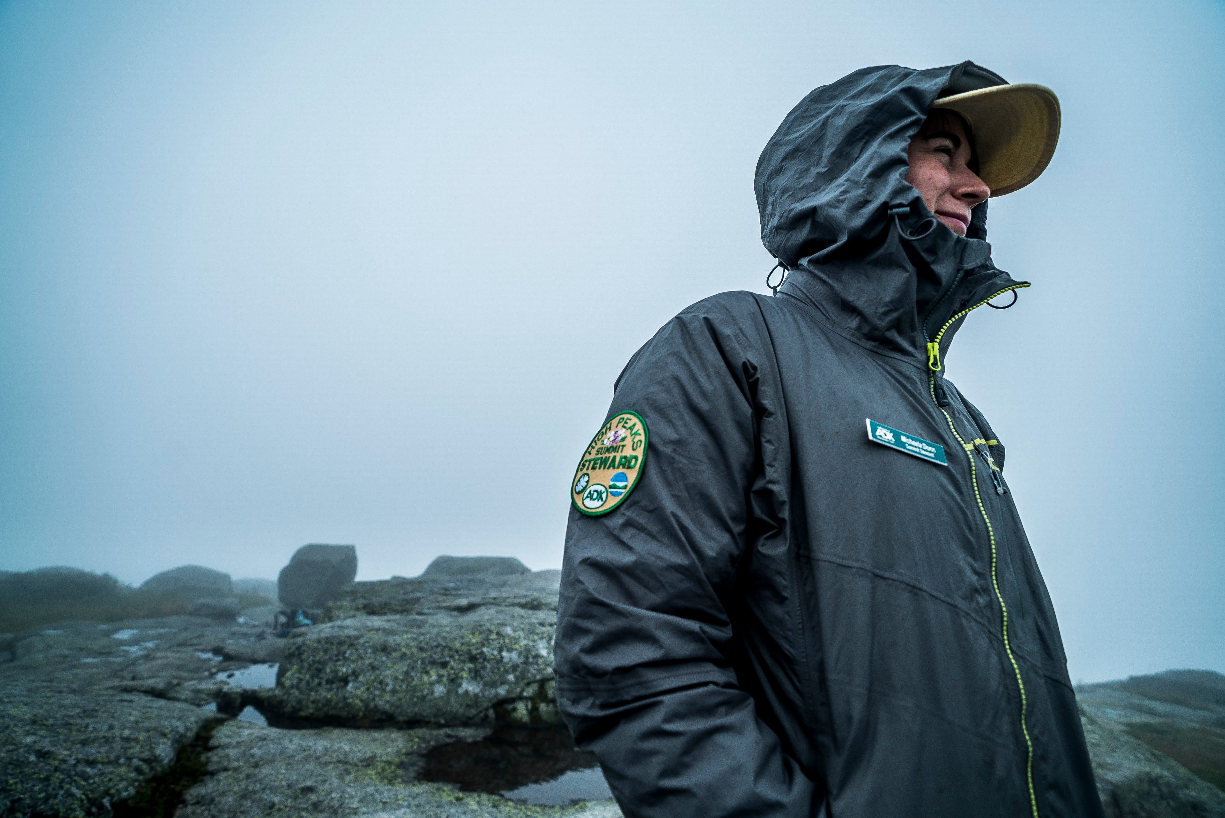 Summit Steward Michaela Dunn with the Adirondack Mountain Club watches over Algonquin Peak on Saturday, Aug. 10, 2019, quick to intercept hikers and educate them about staying on the rock and off the fragile Alpine plants and grasses as well as the gravel mineral pools, crucial for plant grown. Steward efforts at summits across the Adirondacks have saved plants that were disappearing from peaks decades ago.