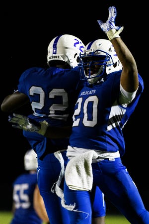 Woodmont's Joshua Kamoto (22) and Rashun Kennedy (20) celebrate during their game against Greenville Friday, Aug. 23, 2019.