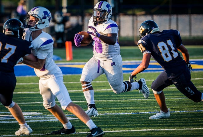 Muncie Central running back Shoka Griffin attempts to run by a defender during a game against Delta during the 2019 season.