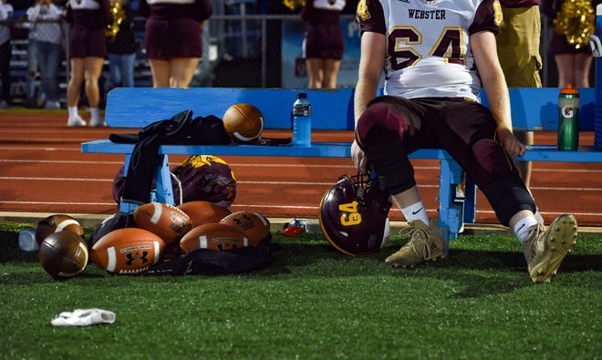 Kaden Lesnar of the Webster Area Bearcats sits on a bench after coming off the field during a game against the Garretson Blue Dragons on Friday night, August 23, in Garretson.