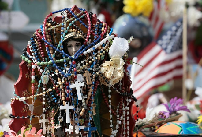 Dozens of rosaries hang from a statue of La Virgen de Guadalupe at the Walmart memorial site in East El Paso on Saturday, Aug. 24, 2019.