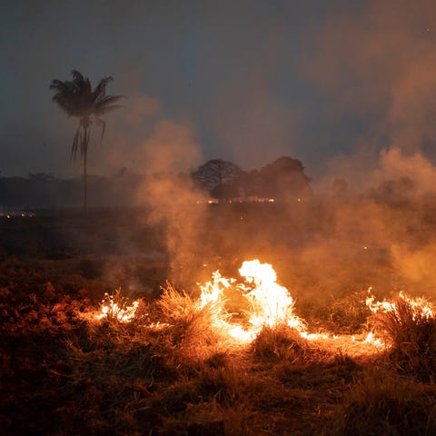 A fire burns a field on a farm in the Nova Santa H