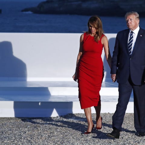 President Donald Trump and Melania Trump walk afte