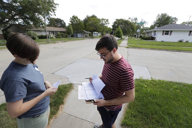 Emma Reading, left, and Tom Lee, both of Appleton, collaborate to canvas a southside neighborhood as part of a 2020 election grassroots plan for the Democratic Party of Outagamie County on Aug. 24 in Appleton.
