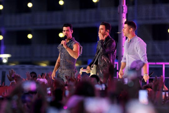 The Jonas Brothers perform Sunday night on the boardwalk in Asbury Park, N.J. They were filming their appearance for Monday's MTV VMAs.