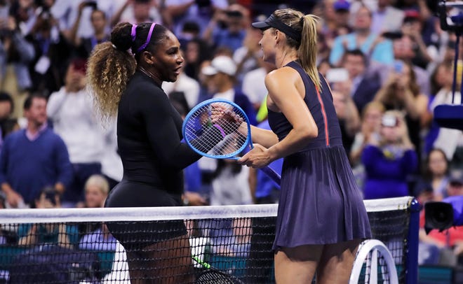 Serena Williams, left, shakes hands with Maria Sharapova after their first-round match Monday at the U.S. Open tennis tournament.