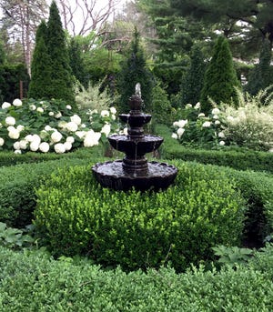 Sue Libertiny says the fountain was added to her English-inspired garden a few years ago. Libertiny's photo, "Boxwood and Hornbeam," is this week's winner of the Homestyle Garden Photo Contest.