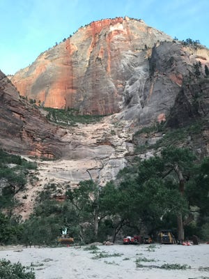 Work crews arrive to dig through the debris left by a major rockfall at Zion National Park on Saturday, Aug. 24, 2019. The rockfall started from a spot about 3,000 feet above the canyon floor and injured three hikers, according to park officials.