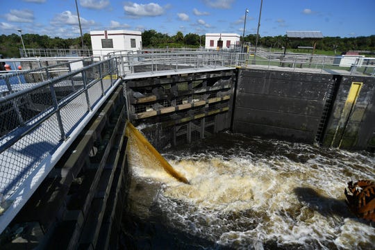 Brown water coming from the Lake Okeechobee side of the St. Lucie Canal (C-44) fills the boat lock for two west-bound vessels on Tuesday, Aug. 27, 2019, at the St. Lucie Lock & Dam, operated by the U.S. Army Corps of Engineers, in Martin County.