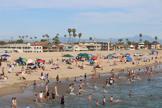 Wide, sandy beaches welcome rows of sunbathers in Seal Beach.