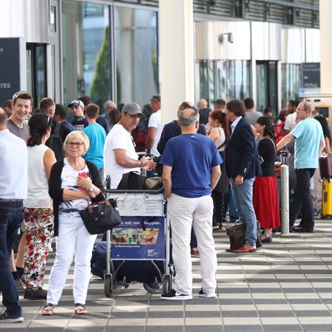 People wait outside the Munich Airport in Munich, 