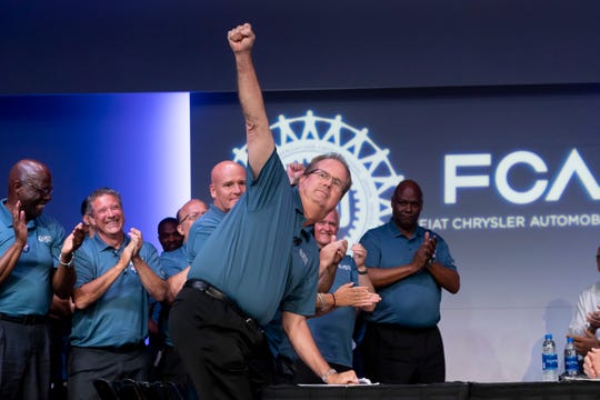 UAW President Gary Jones raises his fist in acknowledgment while being introduced before a ceremonial handshake to mark the beginning of negotiations between the United Auto Workers and Fiat Chrysler Automobiles in July. Jones' home in Canton Township was raided by federal agents Wednesday.