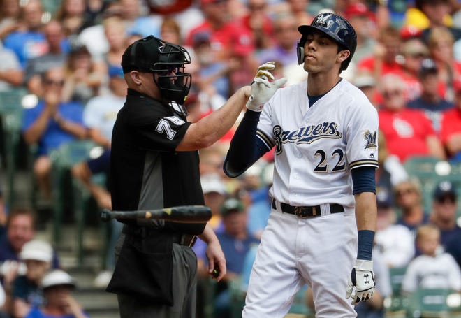 Brewers star Christian Yelich tosses his bat aside after striking out looking against Cardinals starting pitcher Jack Flaherty on Wednesday, Aug. 28.