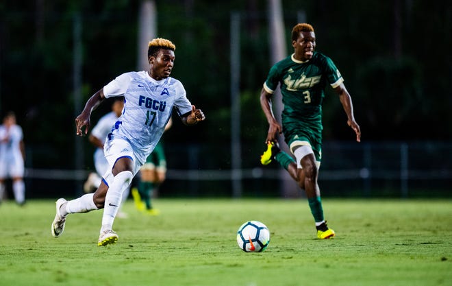FGCU's Shak Adams advances with the ball during a game against USF last September.