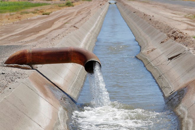 A low-level irrigation ditch is fed fresh water from the Colorado River, Tuesday, Aug. 27, 2019 in Casa Blanca, Ariz. Across the Southwest, people are longing for the monsoon rain like a lost summer romance. They're declaring their love online for the seasonal weather pattern that makes the scorching heat somewhat bearable in places like Phoenix and Las Vegas, and helps snuff out wildfires. They're peering out their windows for signs of storm clouds rolling in and calling rain drops a tease. And they're not giving up hope, despite many cities experiencing their driest summers on record. (AP PhotoMatt York)