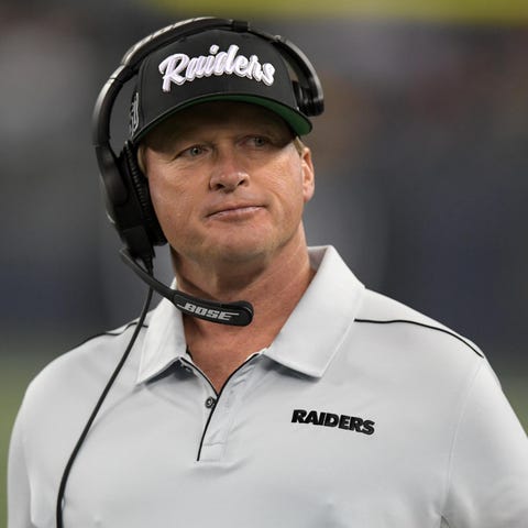 Jon Gruden watches from the sidelines during the p