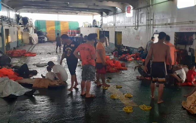 A handout picture made available by Philippine Coast Guard (PCG) shows passengers and coast guard rescuers following a ferry fire off Dapitan city, Zamboanga del Norte province, Philippines, 28 August 2019.