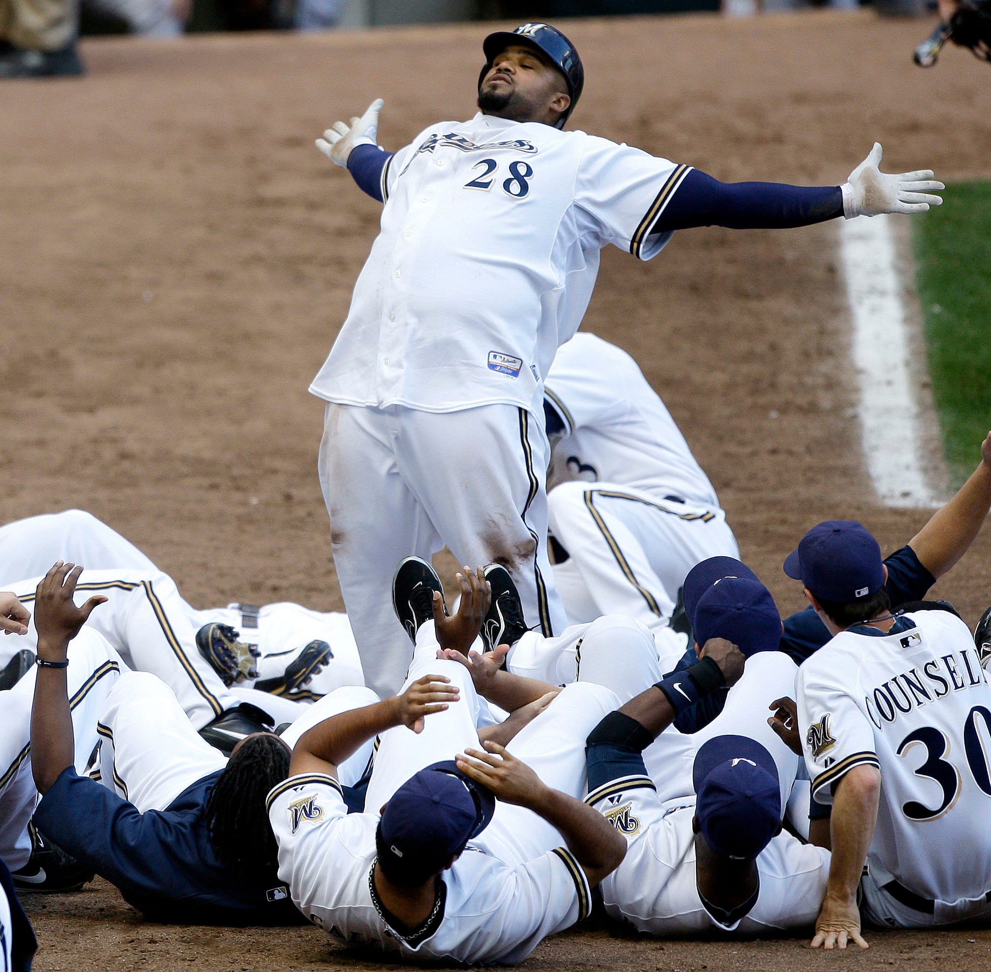 Prince Fielder celebrates a walk-off home run at the plate with team, including now-Brewers manager Craig Counsell