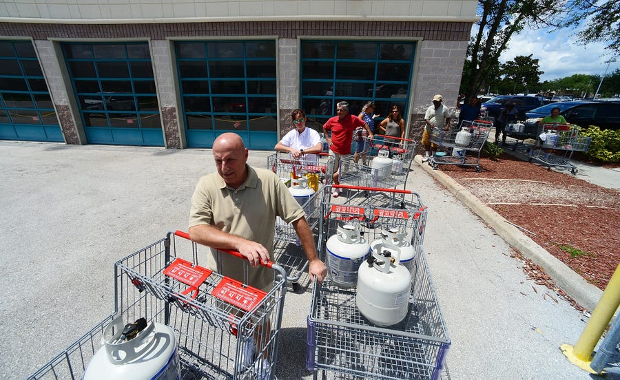 ORLANDO, FLORIDA: Gary DAngelo (L) and central Florida residents  wait on the line to buy propane in preparation for hurricane Dorian at BJ's store on August 29, 2019. The storm is expected to hit Florida as a possible category 4 hurricane over Labor Day weekend.