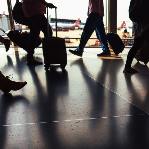 Silhouette of passengers walking through airport h