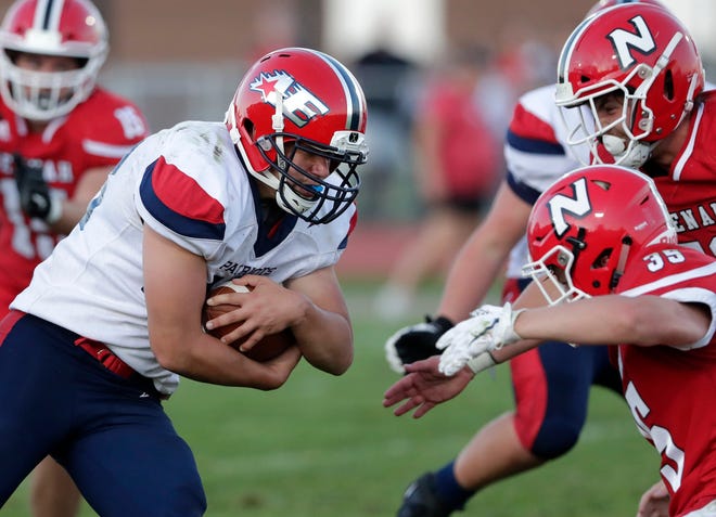 Appleton East's Nick Bouvat looks for rushing yards against Neenah on Aug. 29, 2019. Bouvat and other Appleton city public school athletes will have the fall season pushed back to the spring, the Appleton Area School District announced Friday.