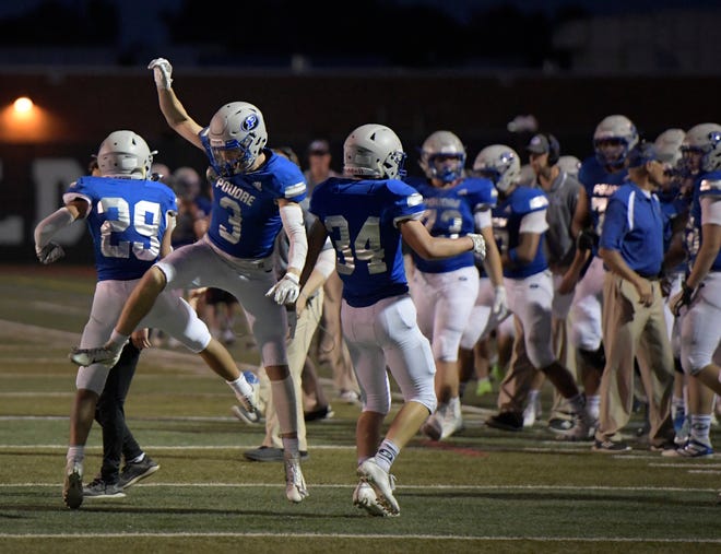 Poudre High School football players celebrate a fourth-down stop in a win over Arvada West on Aug. 29, 2019. The Impalas host Cherokee Trail at 7 p.m. Friday at French Field.