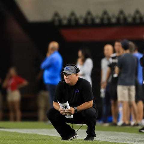UCLA coach Chip Kelly watches his team from the si
