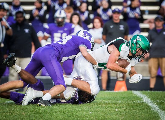 Yorktown's Austin Hill fights for yards against Central during their game at Central Friday, Aug. 30, 2019. 