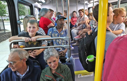 Riders pack into a Red Line bus on opening day, Sunday, Sept. 1, 2019.