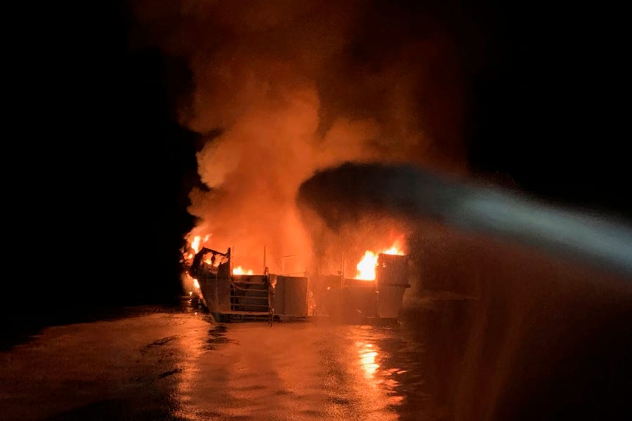 Ventura County Fire Department firefighters respond to a boat fire off the coast of southern California. The U.S. Coast Guard said it has launched several boats to help over two dozen people "in distress" off the coast of southern California. 