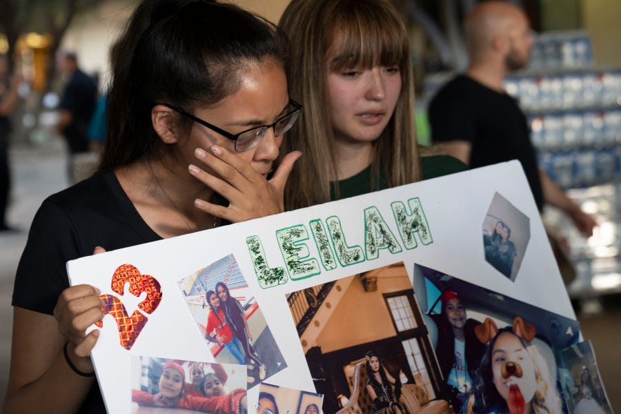Odessa, TX -- Yasmin Natera 16, on the left, and Celeste Lujan, 15, cries for one of their friends who was a victim in a mass shooting in Odessa. The community came together at The University of Texas to pay respect to the victims. The death toll rose to seven Sunday after a gunman's rampage that left many more injured following what began as a routine traffic stop in Odessa, police in the West Texas city said.